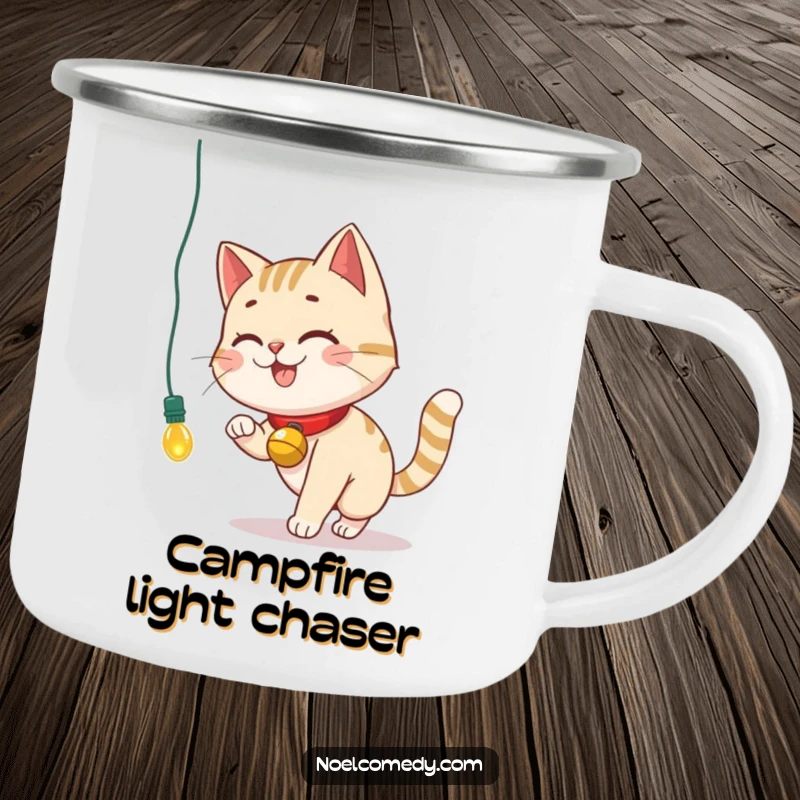 Funny Camping Mug showing a smiling cat with a bell collar chasing a dangling Christmas light, ideal for outdoor lovers.