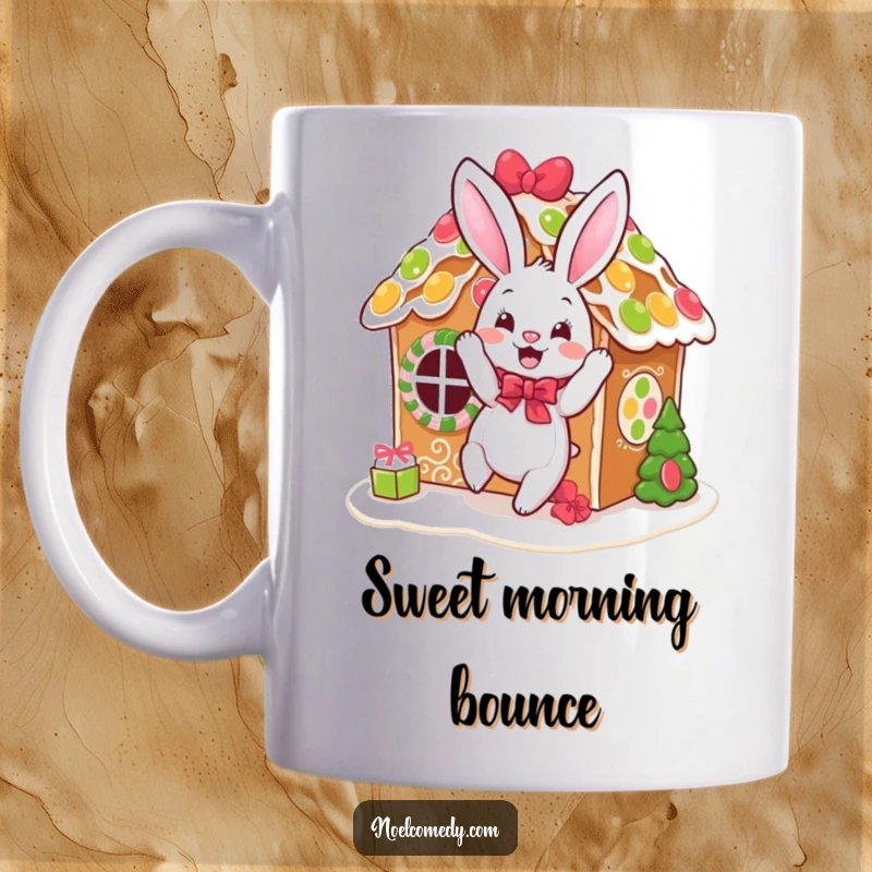 Funny mug showcasing a happy, bouncing bunny festively decorating a gingerbread house with icing and candy sprinkles.