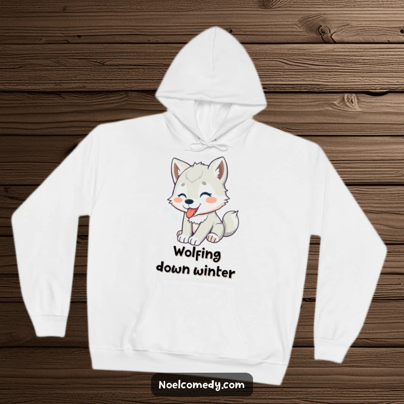 Funny hoodie depicting a playful wolf pup catching snowflakes on its tongue, radiating winter warmth and joy.