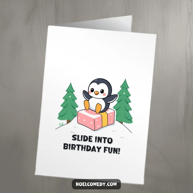 Funny Free Printable Birthday Card: A jubilant penguin joyfully sliding downhill on a brightly wrapped present in crisp snow.