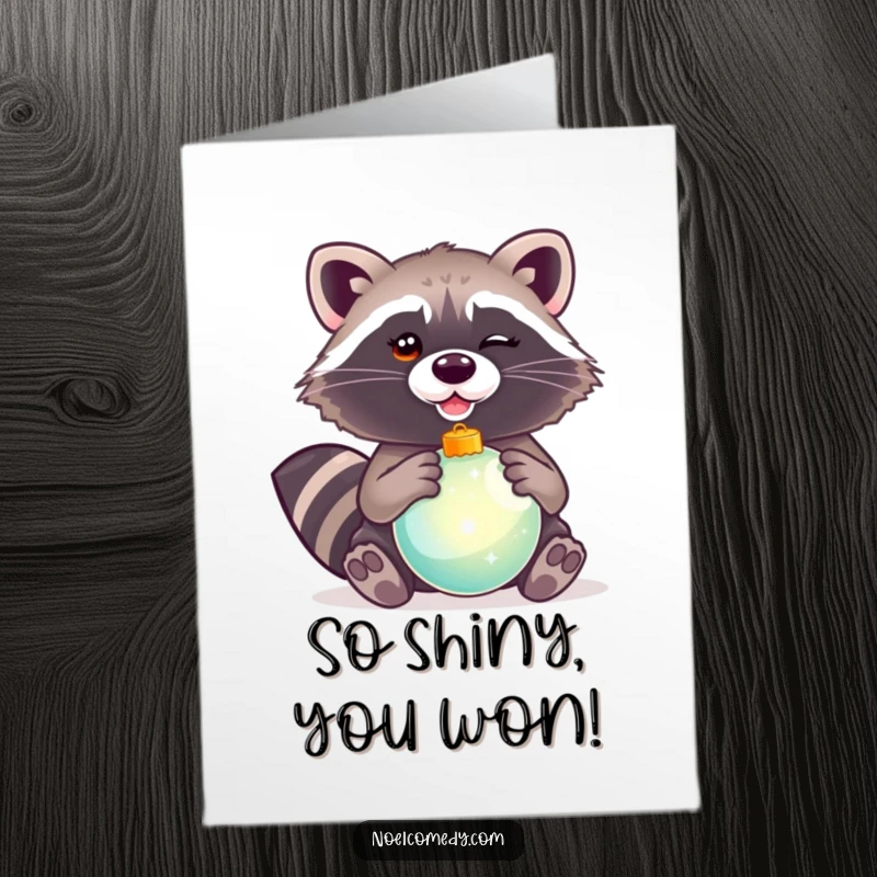 Funny Free Printable Congrats Card: A winking raccoon holding a shiny ornament, symbolizing a sparkling achievement and congratulations.