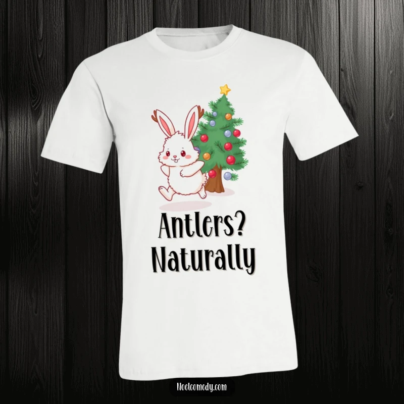 Funny T-Shirt depicting a fluffy bunny donning antlers, joyfully leaping by a festive, decorated evergreen tree.