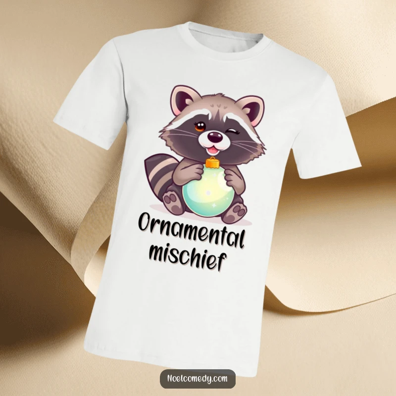 Funny t-shirt with a winking raccoon holding a shiny Christmas ornament, capturing a moment of festive mischief.