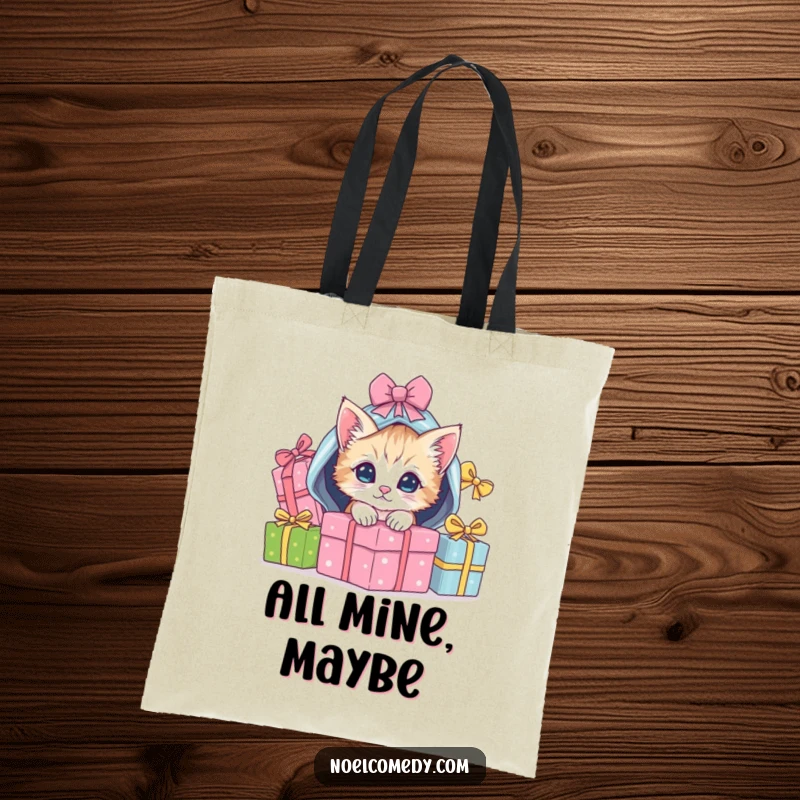 Funny Tote Bag showing a playful kitten peeking from under a pile of wrapped Christmas gifts, ideal for carrying.