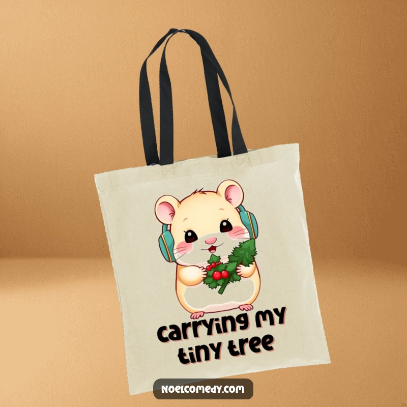 Funny tote bag with a hamster wearing earmuffs and holding a mini evergreen, perfect for winter.