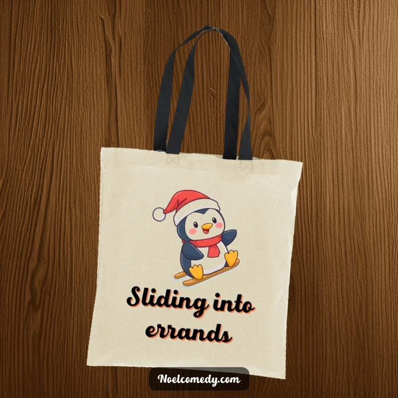 Funny Tote Bag: A cute penguin in a Santa hat, enjoying a slide down a snowy hill, designed for holiday shoppers.